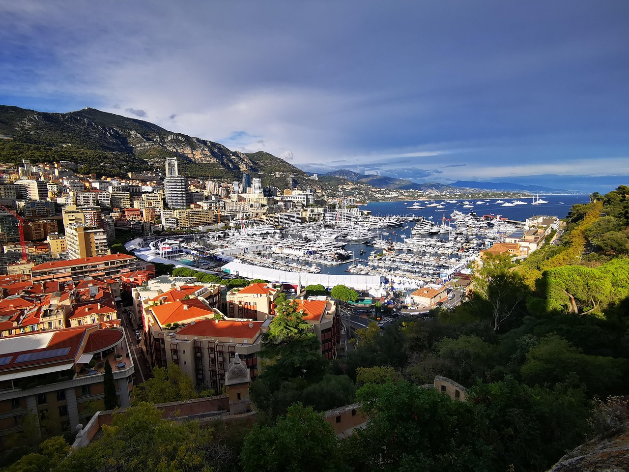 Yachts in Port Hercule with Monaco rising above the Mediterranean